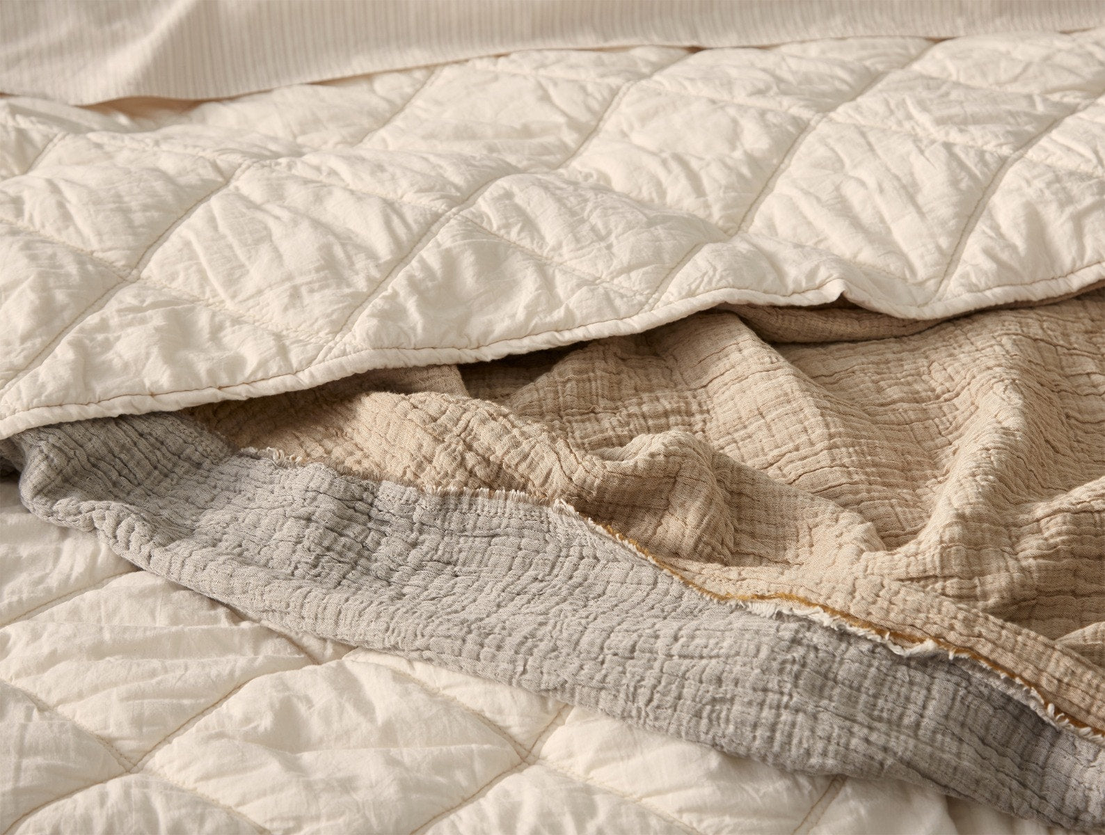 Coyuchi Organic Diamond Stitched Comforter - staged bed close up blankets #colour_undyed