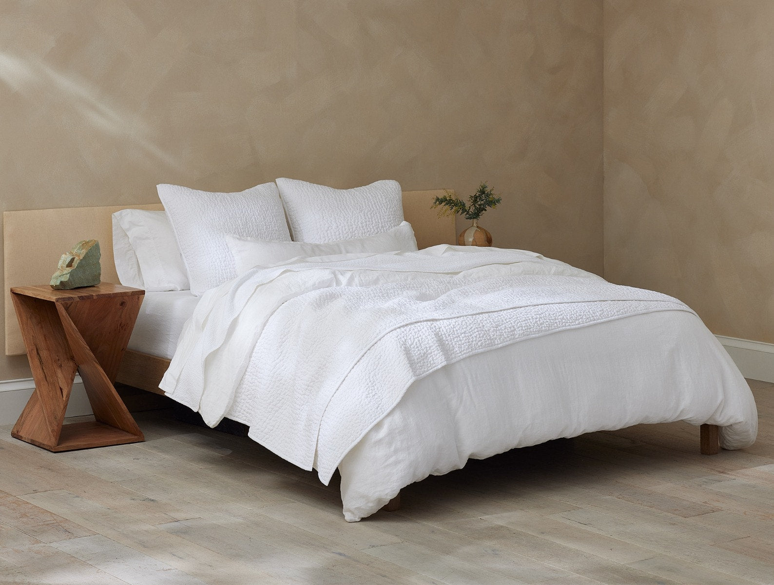 Coyuchi Organic Pebbled Hand Stitched Quilt - staged bed wood side table #colour_alpine white