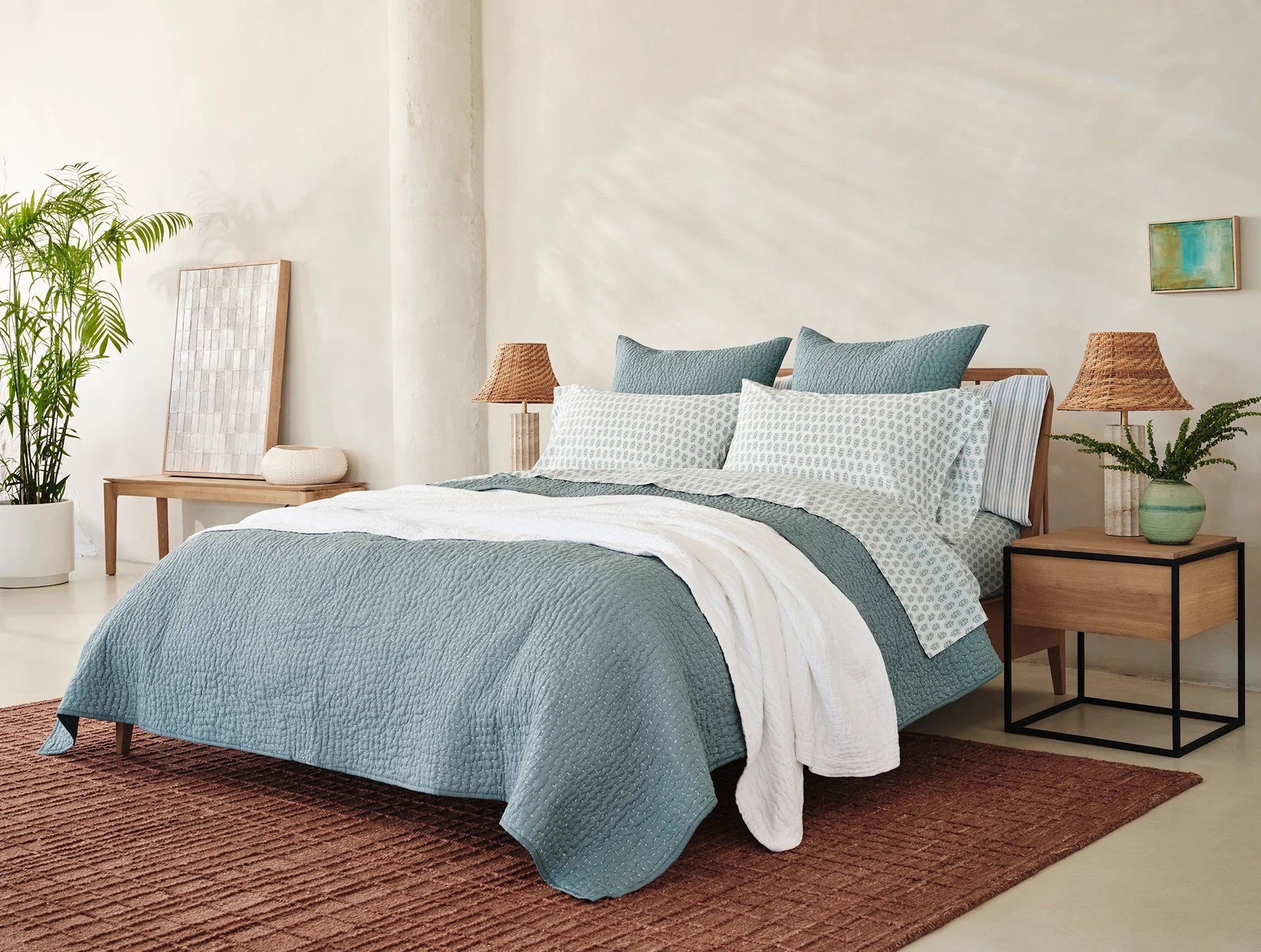 Coyuchi Organic Pebbled Hand Stitched Quilt - staged bed wood side tables with lamps #colour_lagoon