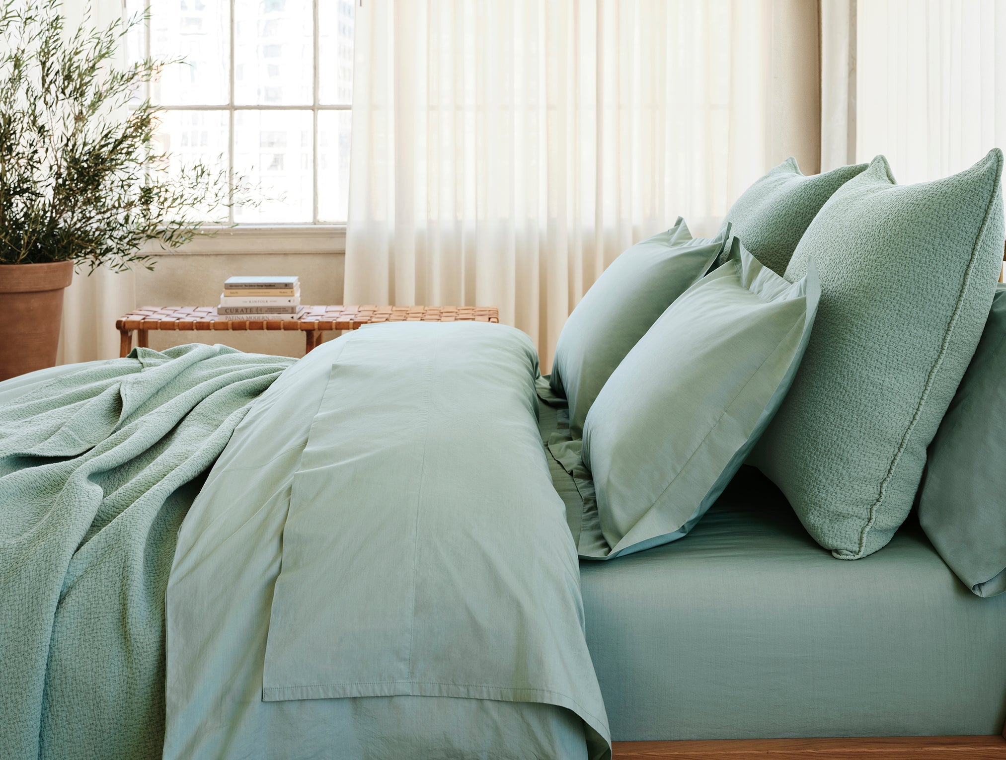 Coyuchi Organic Refined Percale Duvet Cover - staged bed side view #colour_seafoam