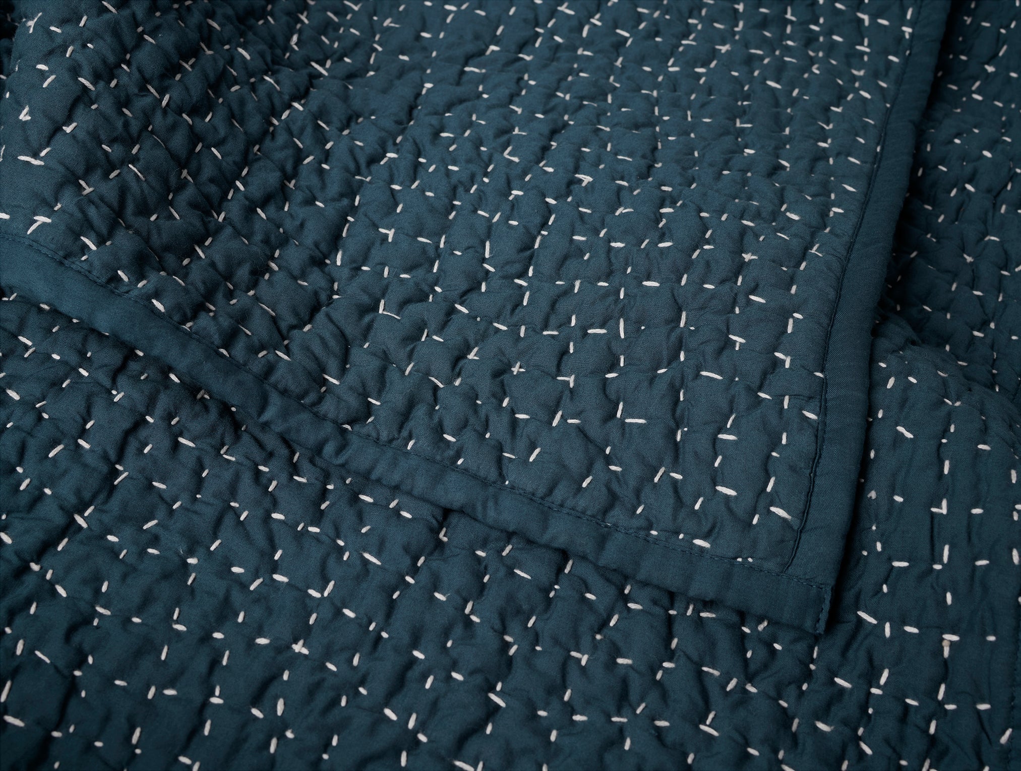 Coyuchi Organic Pebbled Hand Stitched Quilt in Midnight Indigo - close up of corner #colour_midnight indigo