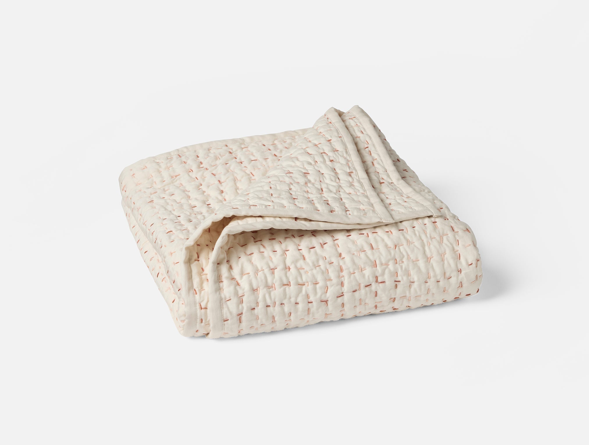 Coyuchi Organic Cotton Pebbled Hand Stitched Toddler Quilt in Undyed with Warms - folded # colour_undyed w/ warms