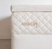 Kakun Organic Latex Mattress Topper in 3 inch - close-up of corner of topper on mattress, showing thickness.