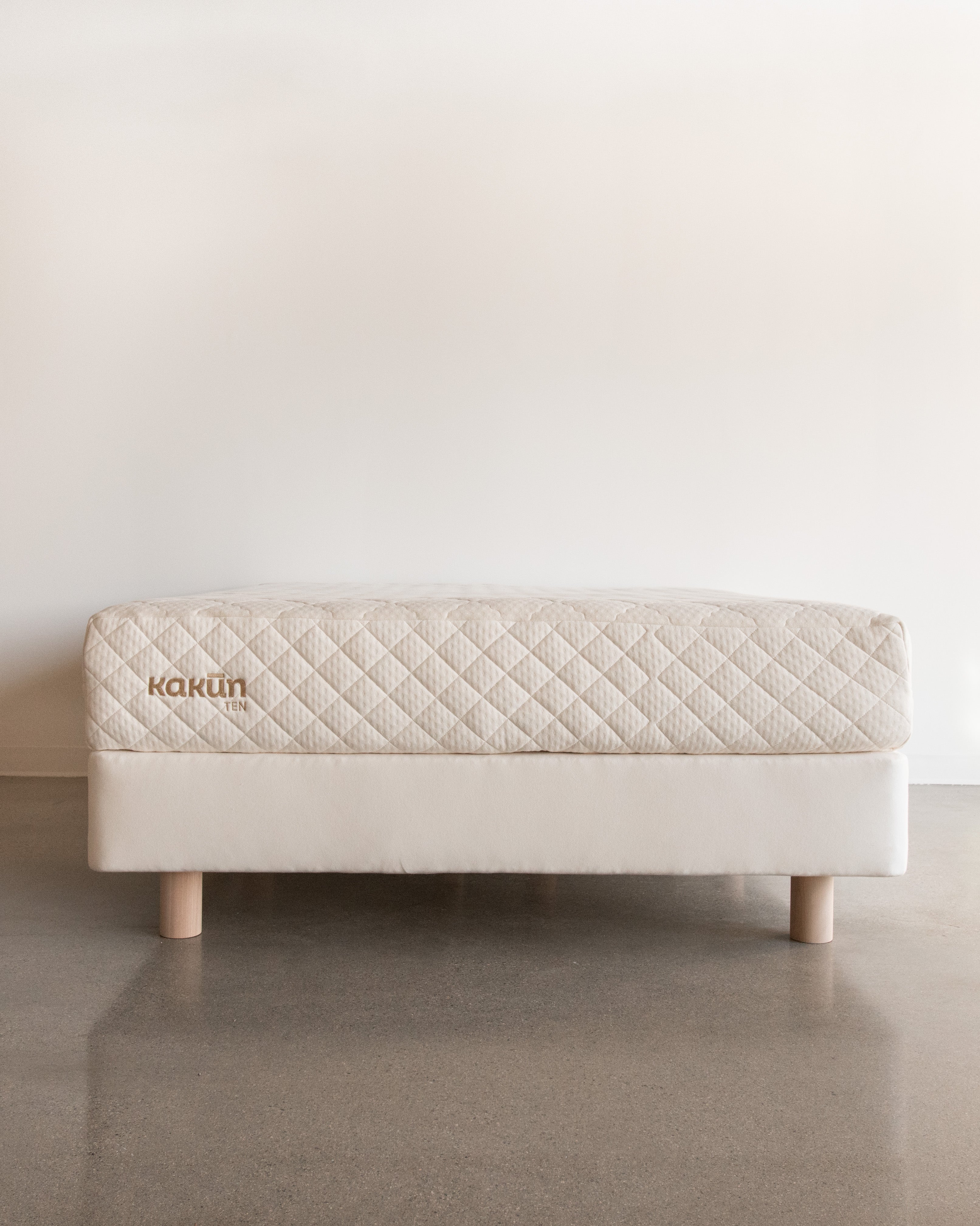 Kakun nine inch organic mattress made in Canada with Kakun logo on an 8 inch Obasan foundation box spring with legs