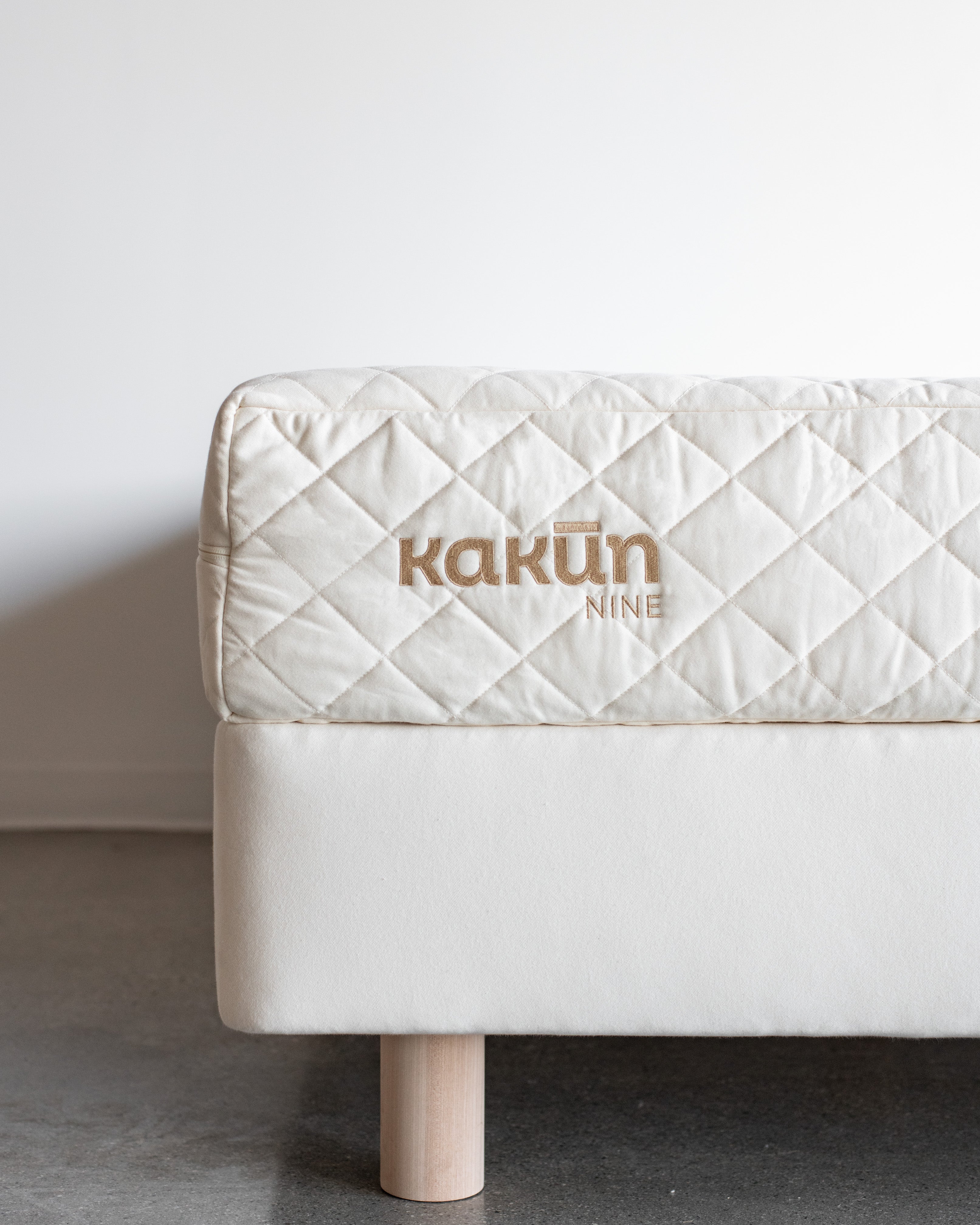 A 9 inch Organic Mattress with Kakun logo on an 8 inch Obasan foundation box spring with legs