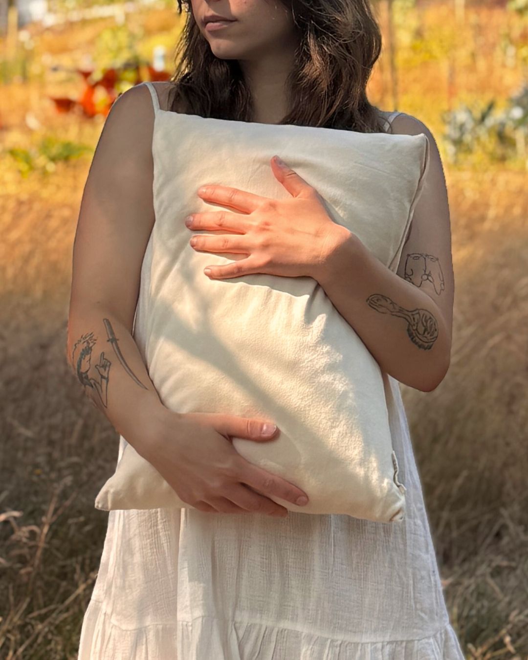Kakun Organic Travel Pillow - held in arms of model