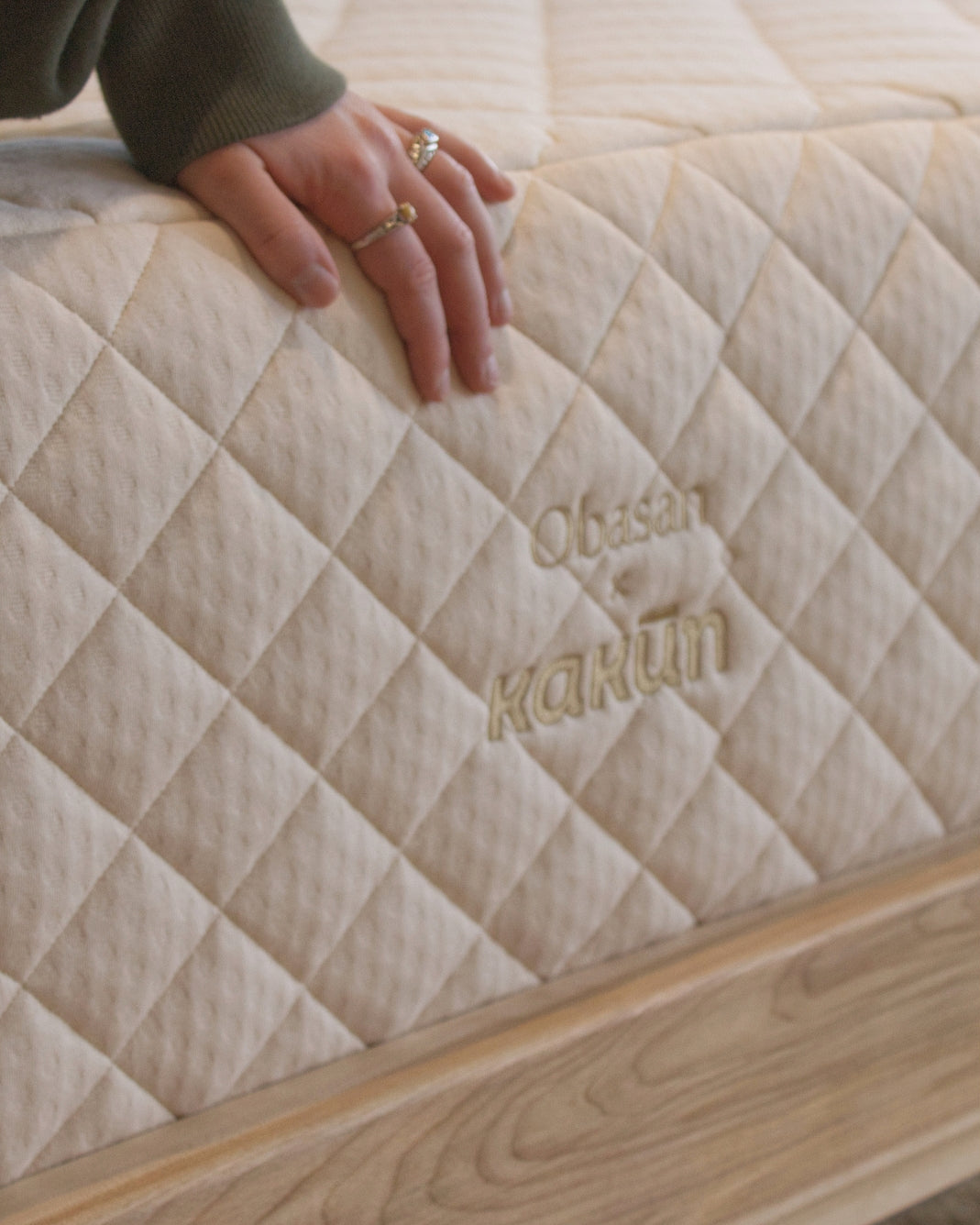 Obasan Kakun 13 inch mattress on a wooden bed frame.