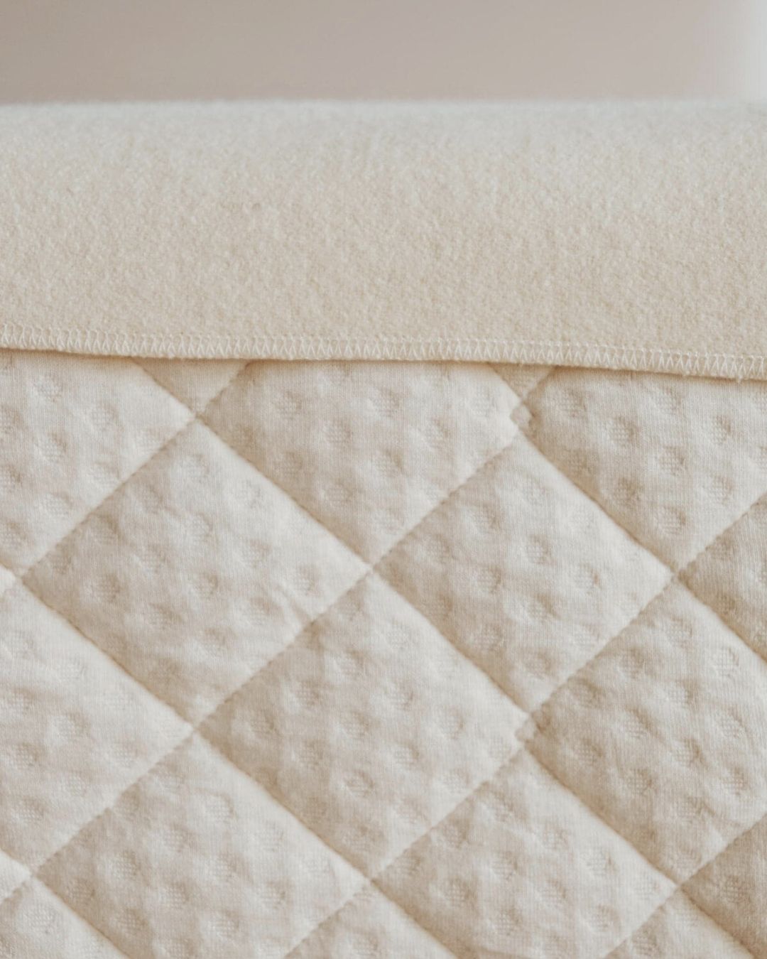 Kakun Wool Mattress Protector - close up on a mattress