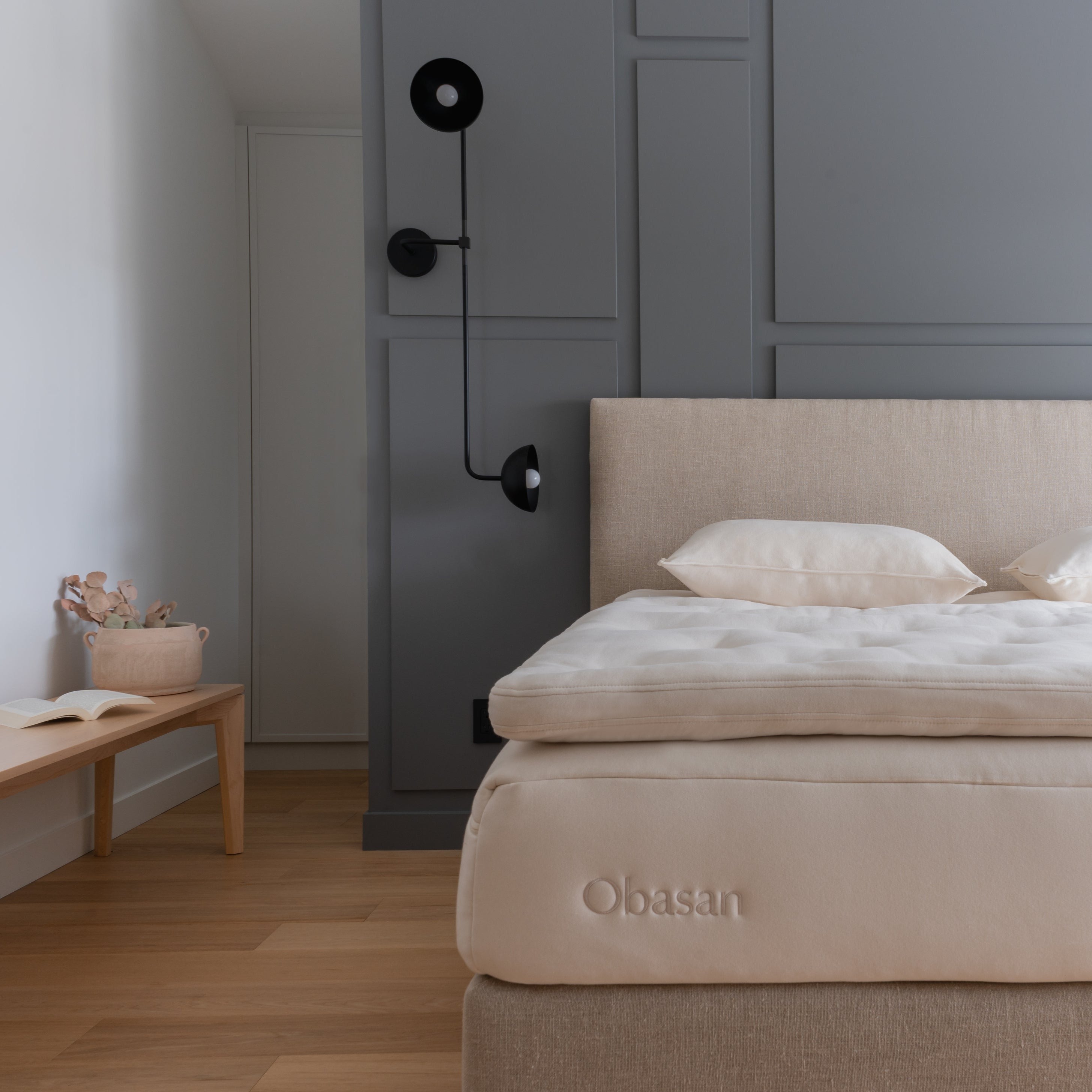 Obasan Deluxe Organic Mattress Topper - half shot of bed with modern styled walls