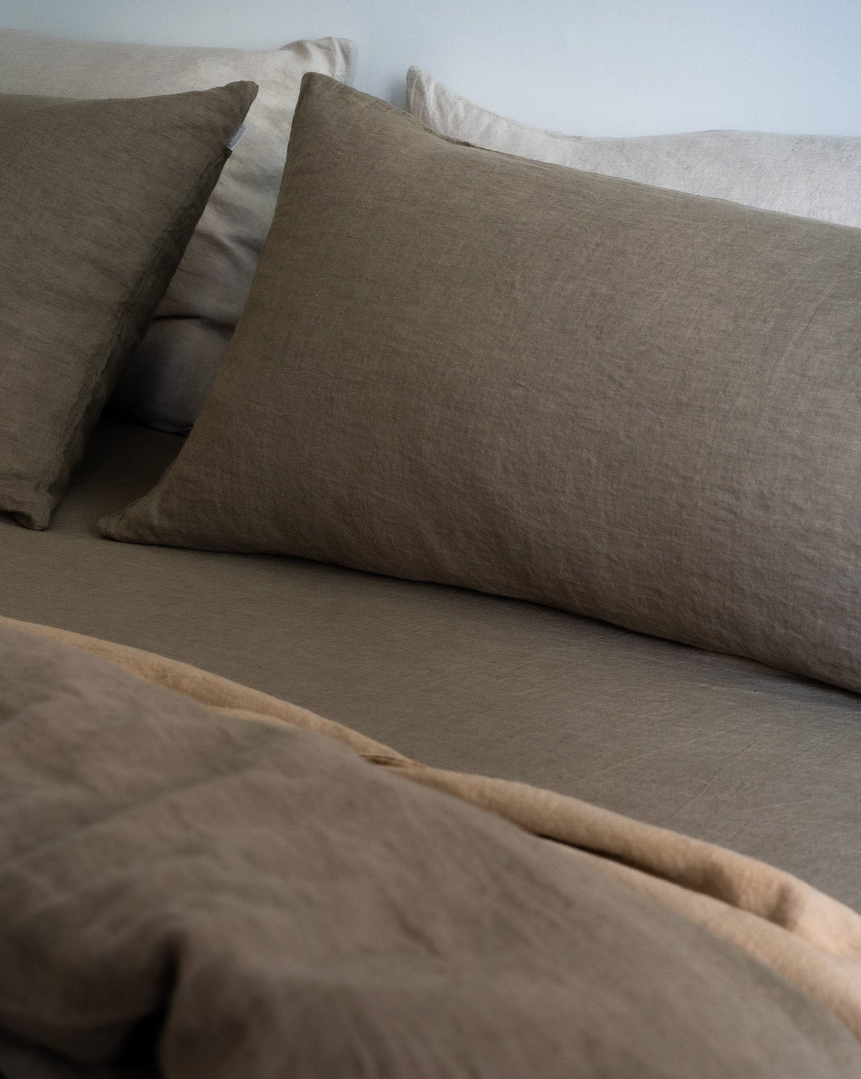 Somn European Linen Pillowcase in Earth - made bed with matching sheets #colour_earth