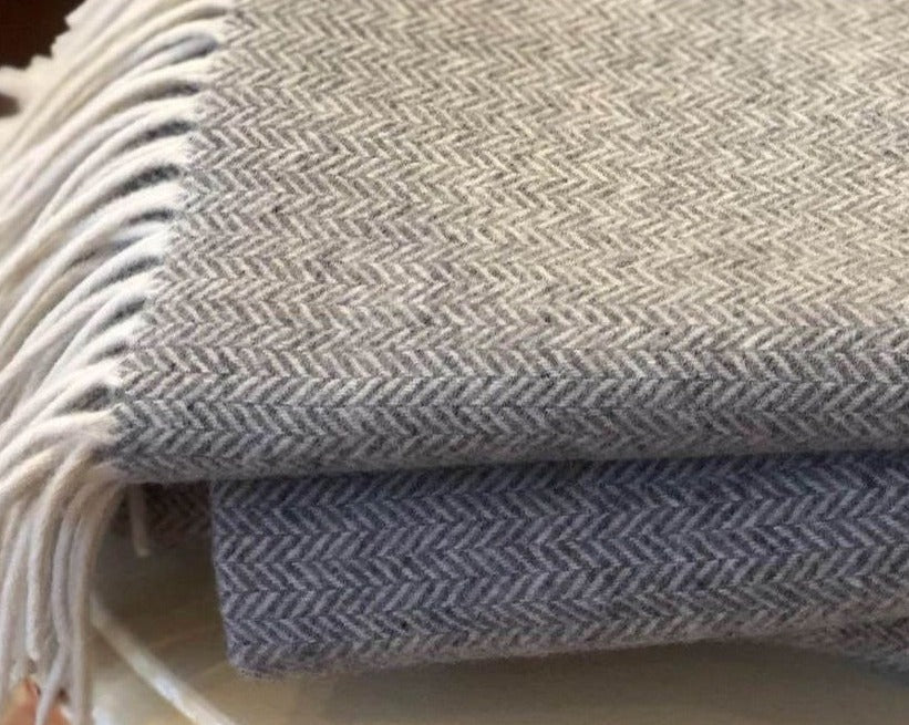 Woven wool comfort, these throws are machine woven in an intricate herringbone pattern.