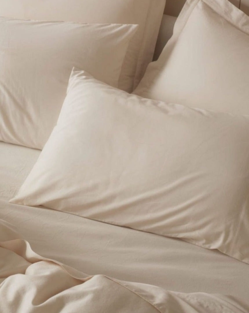 Coyuchi Organic Cloud Soft Sateen Duvet Cover - staged bed zoomed in on pillows #colour_undyed