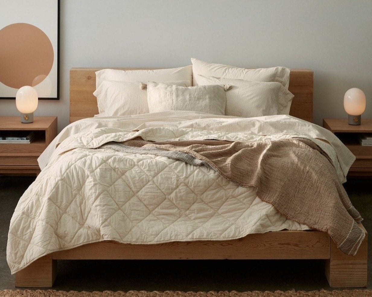Coyuchi Organic Diamond Stitched Comforter - staged bed on wood frame #colour_undyed