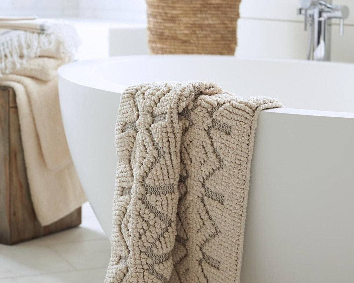 Coyuchi Organic Mosaic Canyon Bath Rug - draped over bath tub #colour_Undyed w/ Slate