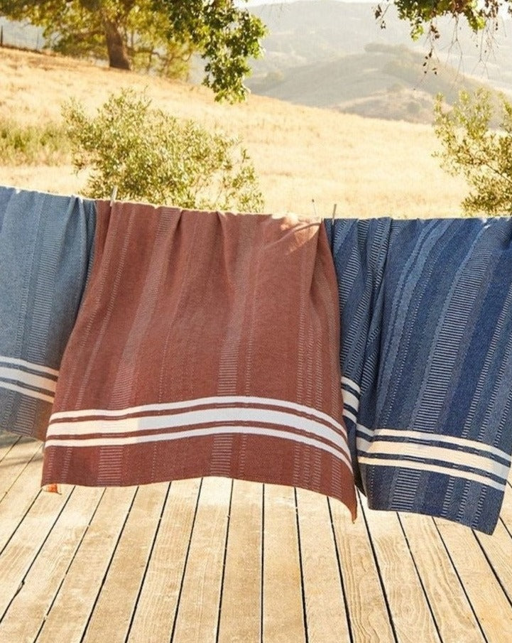 Coyuchi Supersoft Organic Cotton Throw - hung on clothes line in sun outside #colour_midnight